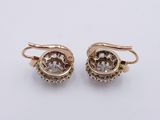 a pair of gold and diamond earrings