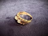 gold plated ring with a leaf design on the side