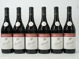 six bottles of red wine lined up in a row