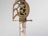 an image of a sword with a gold decoration on the blade