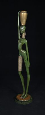 an image of a statue of a woman holding a bowl on her head
