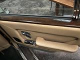 the interior of a car with the door open and the driver ' s seat up