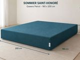 an image of a bed with a blue cover on it