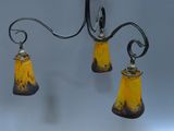 two lamps hanging from a metal pole on a gray background