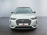 the front view of a white car in a white room