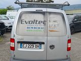 a van that is parked in a lot with other cars