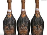 three bottles of champagne sitting next to each other on a white surface