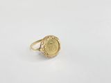 a close up of a gold ring on a white surface