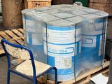 a stack of barrels and a blue chair in a warehouse