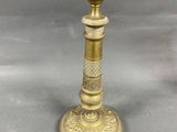 antique brass candle holder with ornate design on base