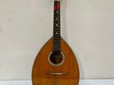an old mandolin sitting on top of a white table