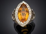 an orange sapphire and diamond ring