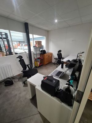 an image of an office with a lot of work on the desks