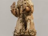a figurine of a woman holding a cat
