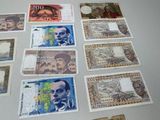 a lot of different bank notes on the table