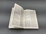 an open book sitting on top of a table next to a gray table
