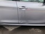 a picture of a silver car parked in a parking lot