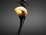 a sculpture of a bird sitting on top of an egg