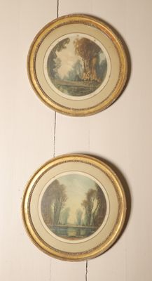 three framed paintings hang on a wall in a room