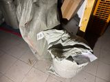 a pile of garbage sitting on the floor next to a refrigerator
