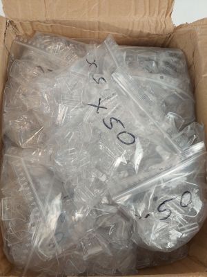 a cardboard box with a lot of plastic items inside of it