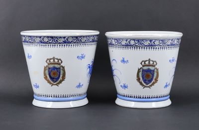 pair of blue and white porcelain cups with crest and crest on them