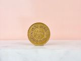 a gold coin sitting on top of a marble counter top