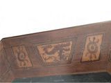 a wooden bench with a decorative design on it