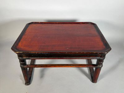 a small wooden table with a tray on top of it