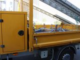 a yellow truck that is parked on the side of the road