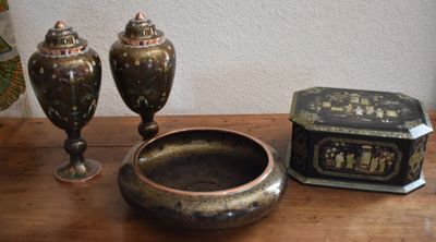 two vases and a box sitting on a table