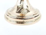 a silver candle holder on a white background