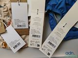 three tags attached to the back of a pair of underwear