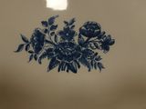 a blue and white plate with a bouquet of flowers on it