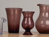 three vases sitting on a table next to each other