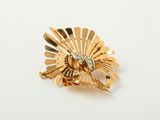 a close up of a gold ring on a white surface