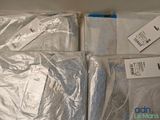 many bags of clothing sitting on top of each other