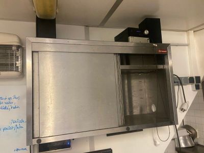 a large stainless steel oven in a kitchen with a whiteboard