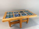 a wooden table with a glass top and a clock on it