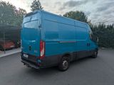 a blue van that is parked in a parking lot