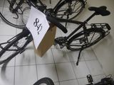 a bicycle that is sitting on the floor with a price tag