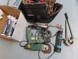a box of tools sitting on a table next to a tool bag