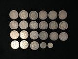 a lot of silver coins on a black surface