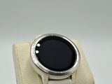 a smart watch sitting on a display stand on a white surface