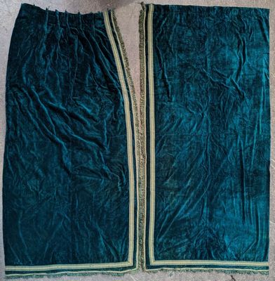 a green velvet jacket with a zipper on the front and a gold zipper on the back