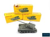 three toy tanks sitting next to each other on a table