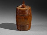 an old wooden container with a wooden lid on a table