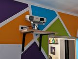 a picture of a room with a mirror and a projector on the wall