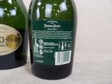two bottles of wine sitting next to each other on a table
