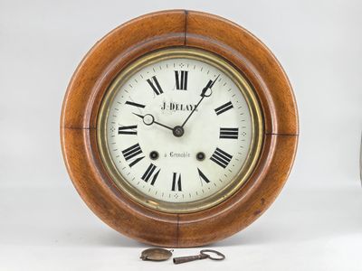 a wooden clock with roman numerals on the face